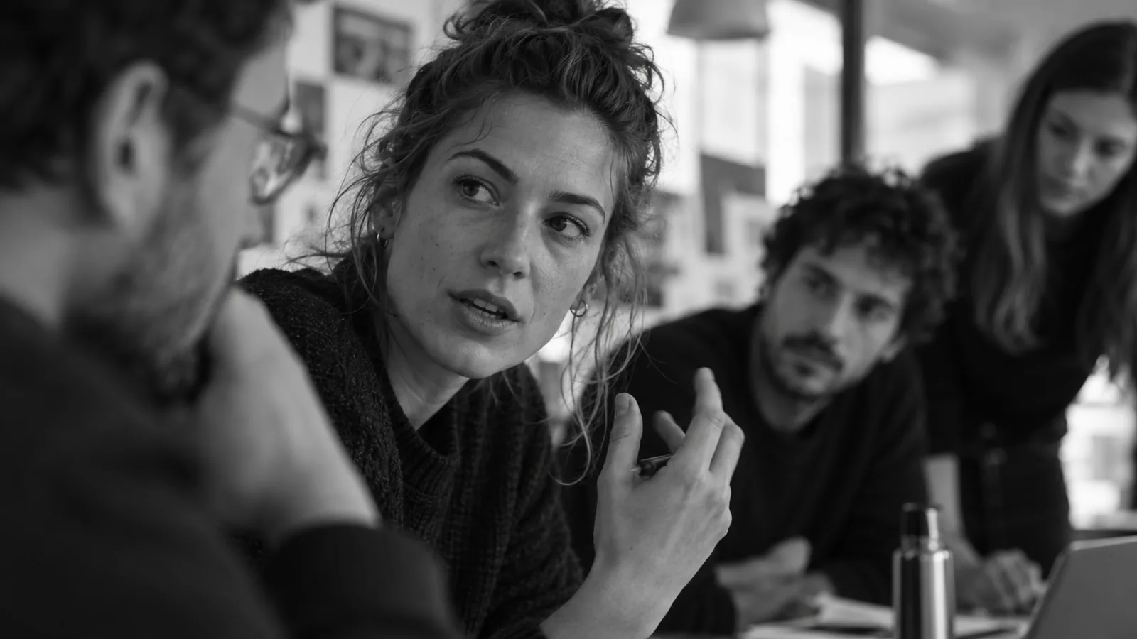 People discuss a project around a table